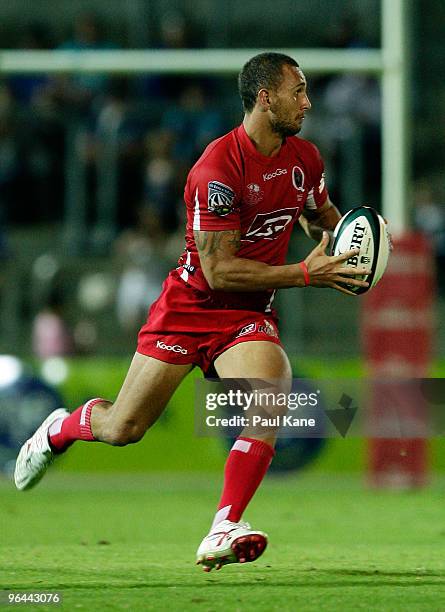 Quade Cooper of the Reds makes a break during the Super 14 trial match between the Western Force and the Reds at ME Stadium on February 5, 2010 in...