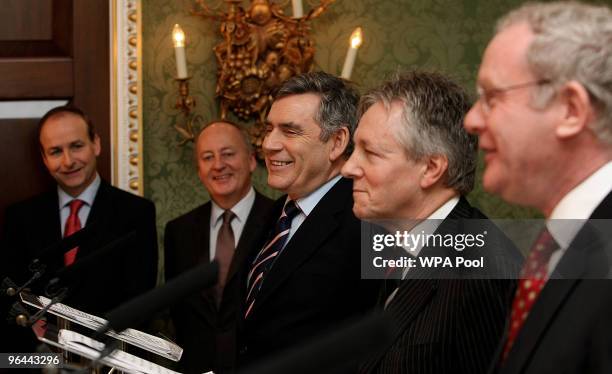 Britain's Prime Minister Gordon Brown , DUP leader Peter Robinson and Sinn Fein's Martin McGuinness speak, watched by Irish Foreign Affairs Minster...