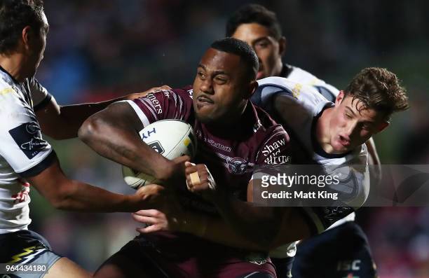 Akuila Uate of the Sea Eagles is tackled during the round 13 NRL match between the Manly Sea Eagles and the North Queensland Cowboys at Lottoland on...