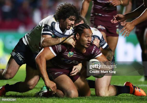 Martin Taupau of the Sea Eagles is tackled during the round 13 NRL match between the Manly Sea Eagles and the North Queensland Cowboys at Lottoland...