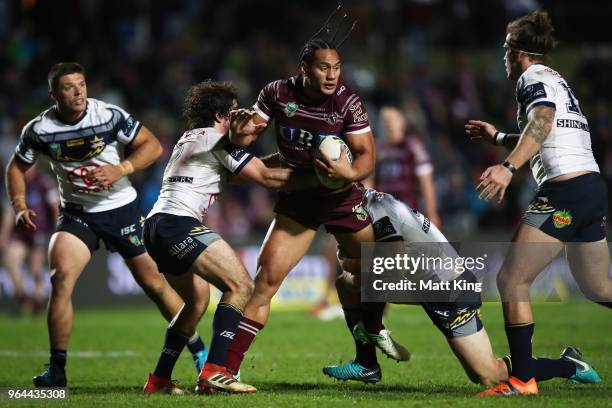 Martin Taupau of the Sea Eagles is tackled during the round 13 NRL match between the Manly Sea Eagles and the North Queensland Cowboys at Lottoland...