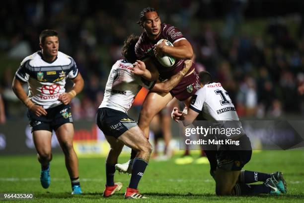 Martin Taupau of the Sea Eagles is tackled during the round 13 NRL match between the Manly Sea Eagles and the North Queensland Cowboys at Lottoland...