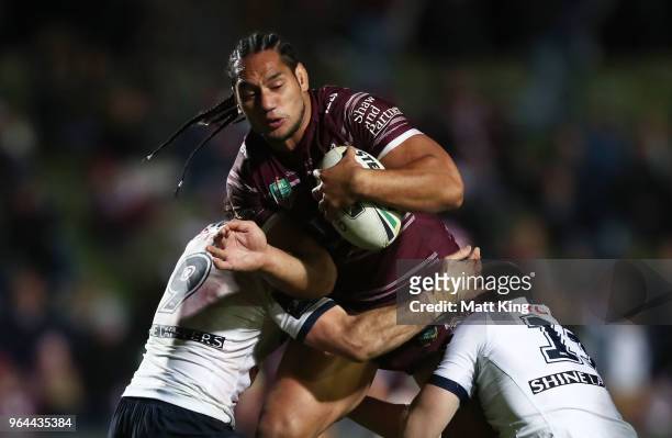 Martin Taupau of the Sea Eagles is tackled during the round 13 NRL match between the Manly Sea Eagles and the North Queensland Cowboys at Lottoland...