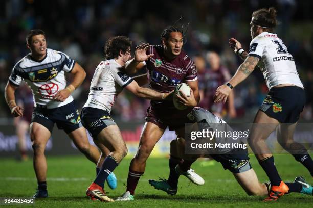 Martin Taupau of the Sea Eagles is tackled during the round 13 NRL match between the Manly Sea Eagles and the North Queensland Cowboys at Lottoland...