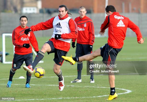 Sotiris Kyrgiakos challenges Philipp Degen as he takes a shot during a Liverpool FC training session at Melwood Training Ground on February 5, 2010...