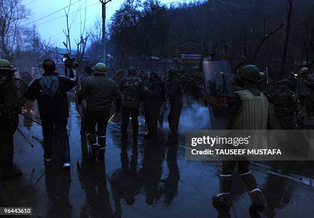 INdian police use teargas to disperse Kashmiris carrying the body of Zahid Farooq who died February 5, 2010 after an altercation broke-out between...