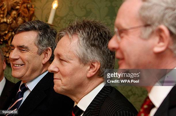Britain's Prime Minister Gordon Brown, DUP leader Peter Robinson and Sinn Fein's Martin McGuinness smile during a press conference after a deal was...