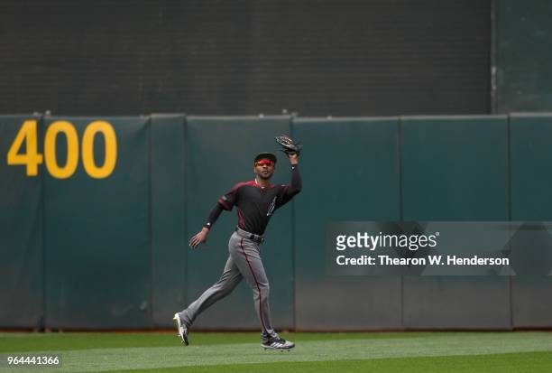 Jarrod Dyson of the Arizona Diamondbacks catches a fly ball off the bat of Dustin Fowler of the Oakland Athletics in the bottom of the fifth inning...