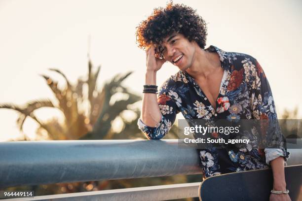 charming young skater - man with curly hair stock pictures, royalty-free photos & images