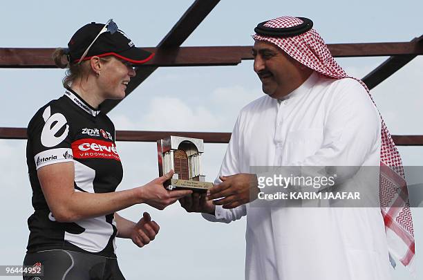 Cervelo Team rider Kirsten Wild of the Netherlands receives her trophy from Sheikh Khaled bin Ali al-Thani, president of the Qatar Cycling...