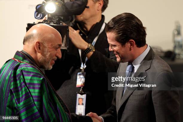 German Defence Minister Karl-Theodor zu Guttenberg welcomes Afghan President Hamid Karzai during the first day of the 46th Munich Security Conference...