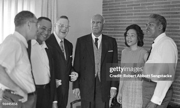 Far left, Nobel Prize-winning political scientist and diplomat Ralph Bunche stands next to Chicago Defender Publisher John Henry Sengstacke in a...