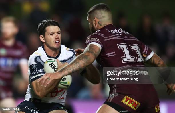 Lachlan Coote of the Cowboys is tackled by Joel Thompson of the Sea Eagles during the round 13 NRL match between the Manly Sea Eagles and the North...