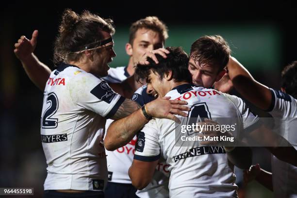 Enari Tuala of the Cowboys celebrates with team mates after scoring a try during the round 13 NRL match between the Manly Sea Eagles and the North...