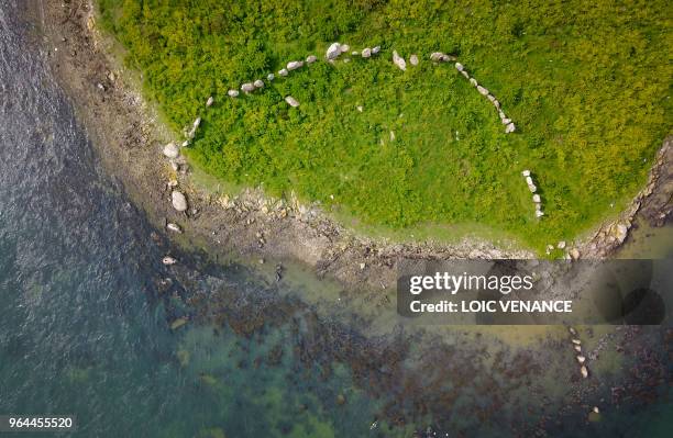 An aerial picture taken on April 30, 2018 shows a Cromlech, a megalithic enclosure made of dolmens, on the Er Lannic island, offshore Arzon, in the...