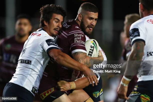 Joel Thompson of the Sea Eagles is tackled during the round 13 NRL match between the Manly Sea Eagles and the North Queensland Cowboys at Lottoland...