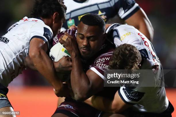 Akuila Uate of the Sea Eagles is tackled during the round 13 NRL match between the Manly Sea Eagles and the North Queensland Cowboys at Lottoland on...