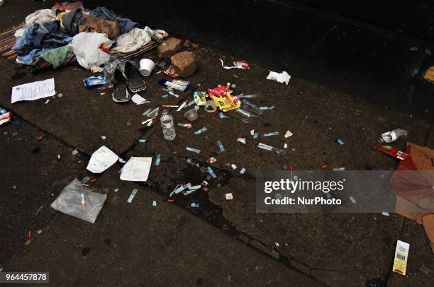 Clothes, needles and other drug paraphilia lay in the spaces between tents and other living areas at a homeless encampment in the Kensington section...