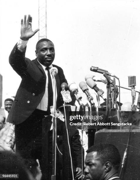 Photo of activist Dick Gregory waving to the crowd assembled to hear Dr. Martin Luther King, Jr. At Wrigley Field, in Los Angeles, May 1963. This was...