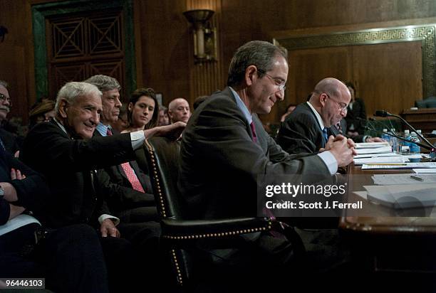 Comcast co-founder Ralph J. Roberts gives son Brian Roberts, chairman and CEO of Comcast Corp., a pat on the back after a heated exchange between his...