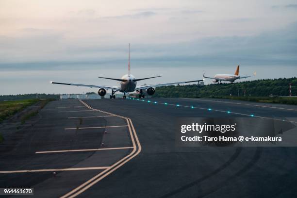 the airplane taking off and landing on tokyo narita international airport in japan - stadt chiba stock-fotos und bilder