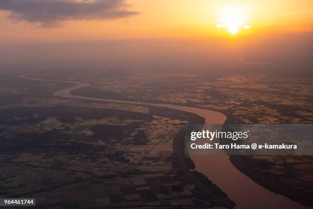 rice paddy and tone river in narita city and kawachi town in japan sunset time aerial view from airplane - narita city stock pictures, royalty-free photos & images