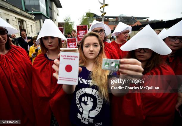 Eleanor Crossey Malone displays an abortion pill packet after taking a pill as abortion rights campaign group ROSA, Reproductive Rights Against...