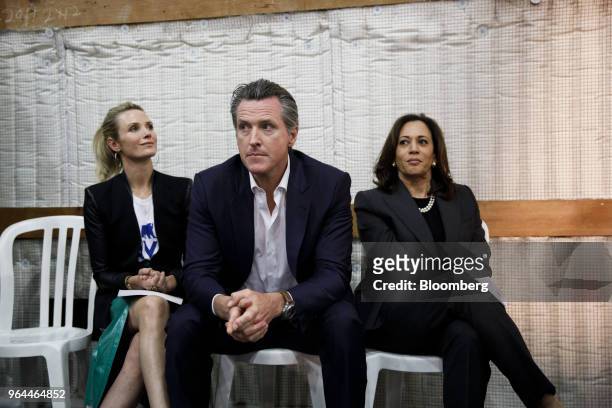 Gavin Newsom, Democratic candidate for governor of California, center, sits next to his wife Jennifer Newsom, left, and Senator Kamala Harris, a...