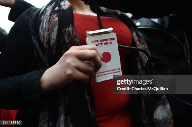 An unindentified woman displays an abortion pill packet after taking one of the pills as abortion rights campaign group ROSA, Reproductive Rights...