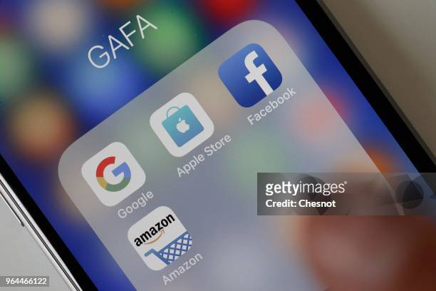 In this photo illustration, logos of the Google, Apple, Facebook, and Amazon applications are displayed on the screen of an Apple iPhone on May 31,...
