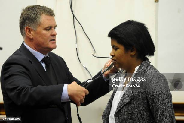 Murder accused Jason Rohde uses a police officer as a model to demonstrate how he found his wife Susans body during his trial at the Western Cape...