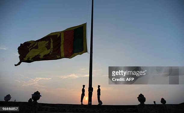Sri Lankan soldiers lower their national flag in the evening of the nation's 62th Independence Day in Colombo on February 4, 2010. Sri Lankan...