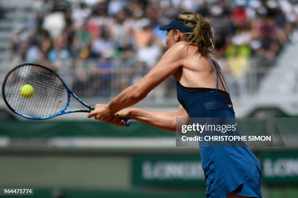 Russia's Maria Sharapova plays a backhand return to Croatia's Donna Vekic during their women's singles second round match on day five of The Roland...