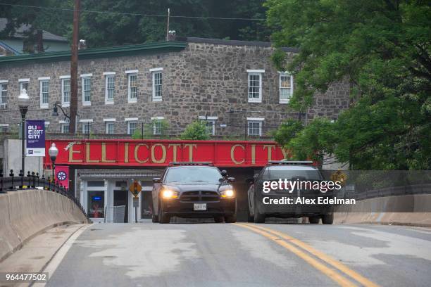 Police Cars block Main Street as the downtown area remains closed under police guard following devastating flooding on May 31, 2018 in Ellicott City,...