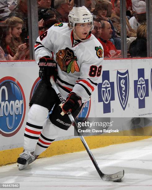 Patrick Kane of the Chicago Blackhawks skates behind the net with the puck during a NHL game against the Detroit Red Wings at Joe Louis Arena on...