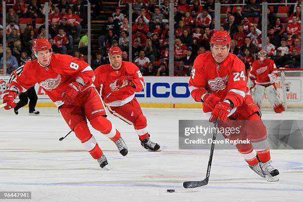 Brad May of the Detroit Red Wings skates up ice with support of teammates Justin Abdelkader and Kirk Maltby during a NHL game against the Chicago...