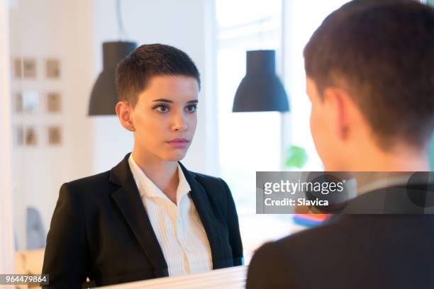 businesswoman checking herself in the mirror - businesswear stock pictures, royalty-free photos & images