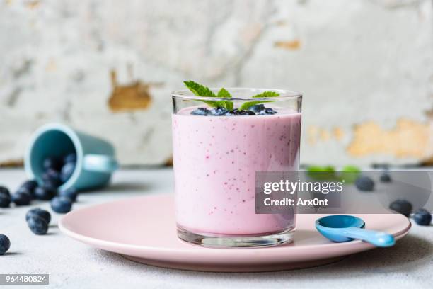blueberry smoothie in glass decorated with mint leaf - frozen yogurt stock pictures, royalty-free photos & images