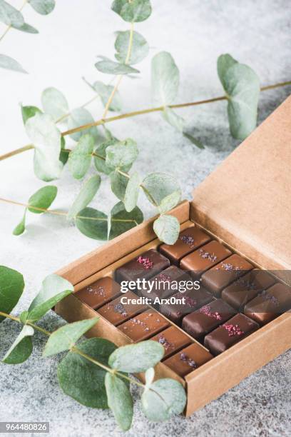 assortment of chocolates and pralines in carton box - theobroma imagens e fotografias de stock