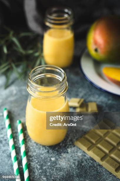fresh mango juice and vegan chocolate - raw green mango stock pictures, royalty-free photos & images