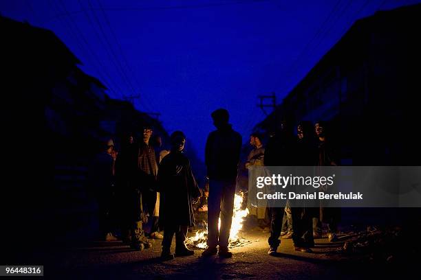 Kashmiri muslim protesters defying curfew gather before throwing stones towards indian police during a protest on February 04, 2010 in Srinagar,...