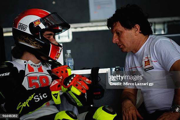 Marco Simoncelli of Italy and San Carlo Honda Gresini speaks with Fausto Gresini of Italy in box during the final day of the MotoGP test at Sepang...