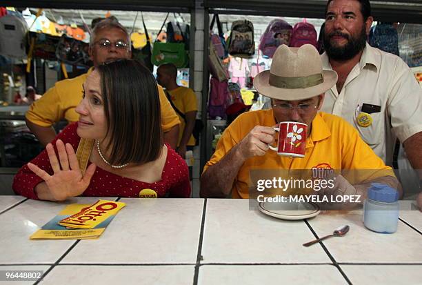 Costa Rican presidential candidate for the Citizen Action Party, Otton Solis , drinks coffee next to his wife Shirley Sanchez during a visit to the...