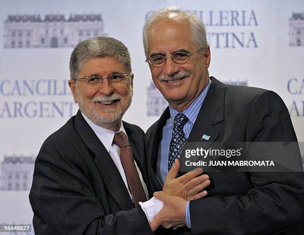 Brazil's Foreign Minister Celso Amorim and his Argentine counterpart Jorge Taiana hug after finishing a news confere in Buenos Aires on February 5,...