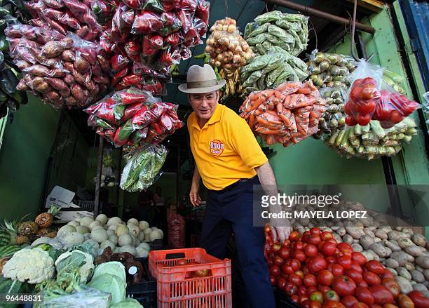 Costa Rican presidential candidate for the Citizen Action Party, Otton Solis, leaves a vegetables stand during a visit to the Central Market of...