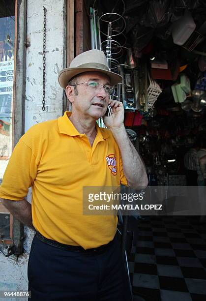 Costa Rican presidential candidate for the Citizen Action Party, Otton Solis, talks on his mobile phone during a visit to the Central Market of...