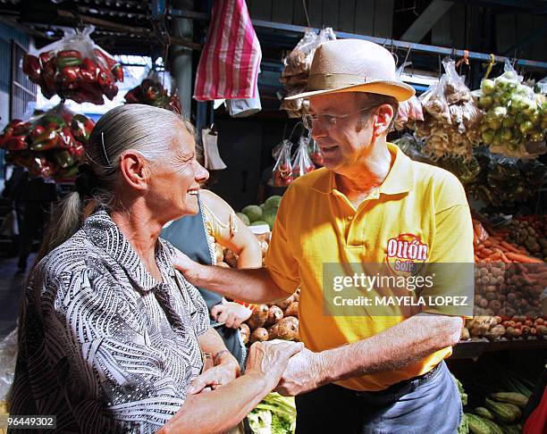 Costa Rican presidential candidate for the Citizen Action Party, Otton Solis, greets a woman on February 5 during a visit to the Central Market of...