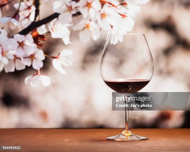 wine in cherry blossoms background - cabernet sauvignon grape stock pictures, royalty-free photos & images