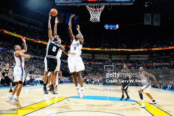 Roger Mason Jr. #8 of the San Antonio Spurs lays up a shot against Thabo Sefolosha and Serge Ibaka of the Oklahoma City Thunder during the game on...