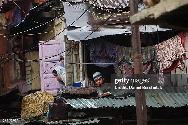 Kashmiri muslim boy looks out of a window during curfew on February 05, 2010 on the outskirts of Srinagar, Kashmir, India. Fresh protests erupted...